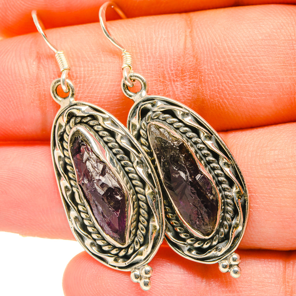 Rough amethyst drop earrings close-up, textured oval silver-tone settings with hooks