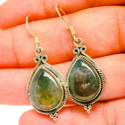 Green moss agate teardrop earrings close-up, ornate bezel, fishhook drops