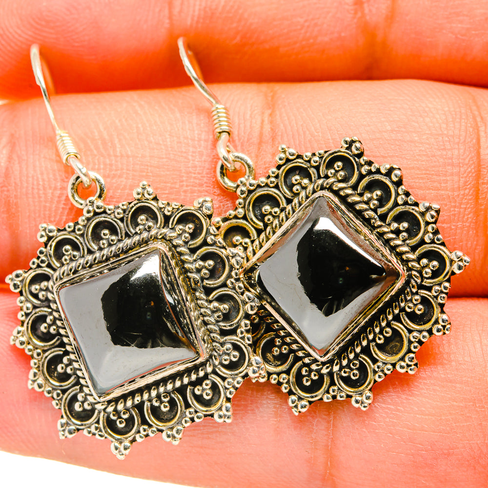 Hematite earrings with square black stone and ornate gold-tone filigree, silver-tone border