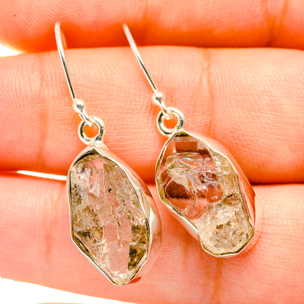 Herkimer diamond earrings with oval faceted stones and circular silver-tone links
