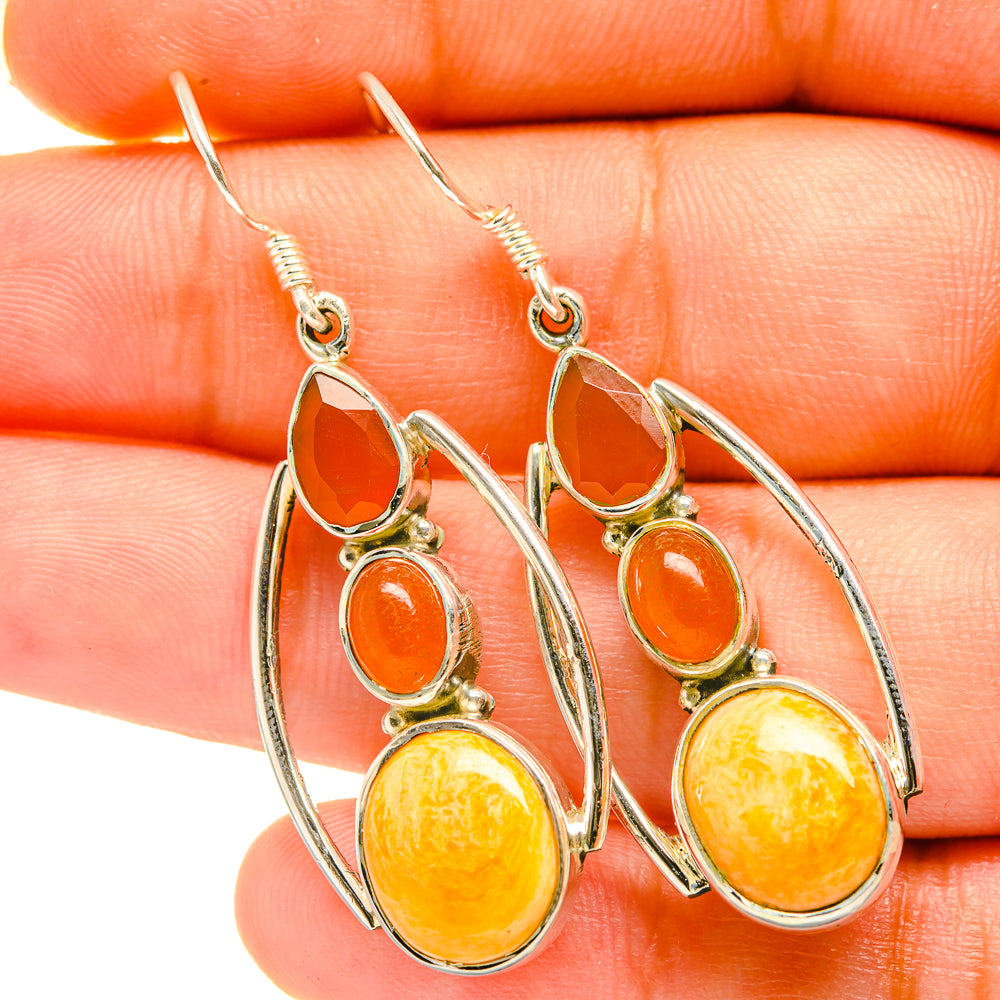 Sterling silver dangle earrings with orange teardrop, oval, and round stones