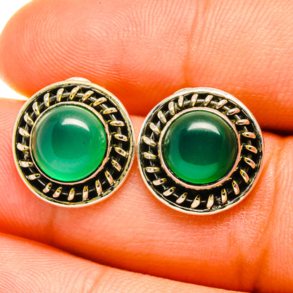 Green onyx stud earrings in ornate sterling silver bezel, round cabochon close-up