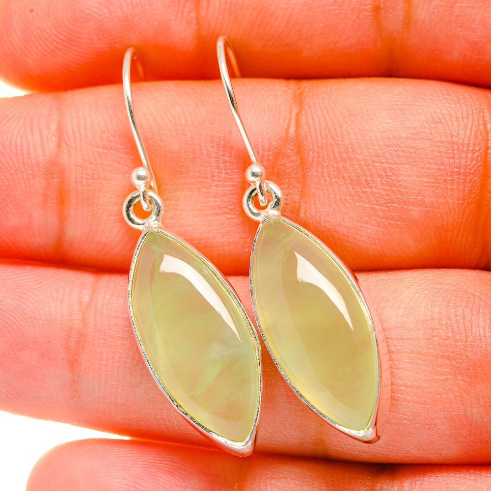 Sterling silver drop earrings with pale green teardrop gemstones, hooked ear wires