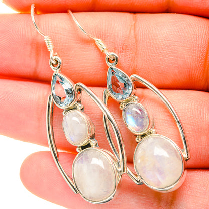 Sterling silver drop earrings with blue teardrop and opalescent moonstone cabochons