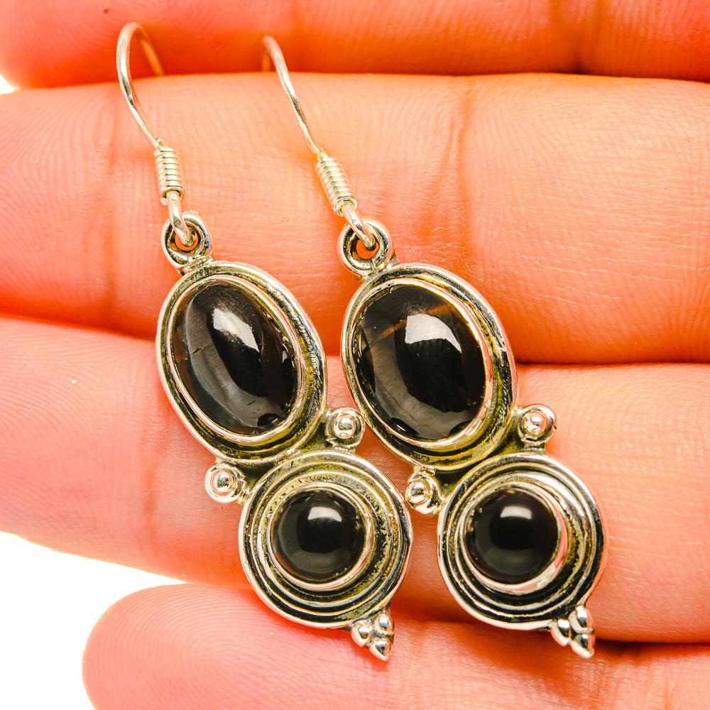 Sterling silver drop earrings with four oval dark stones and fishhook closures