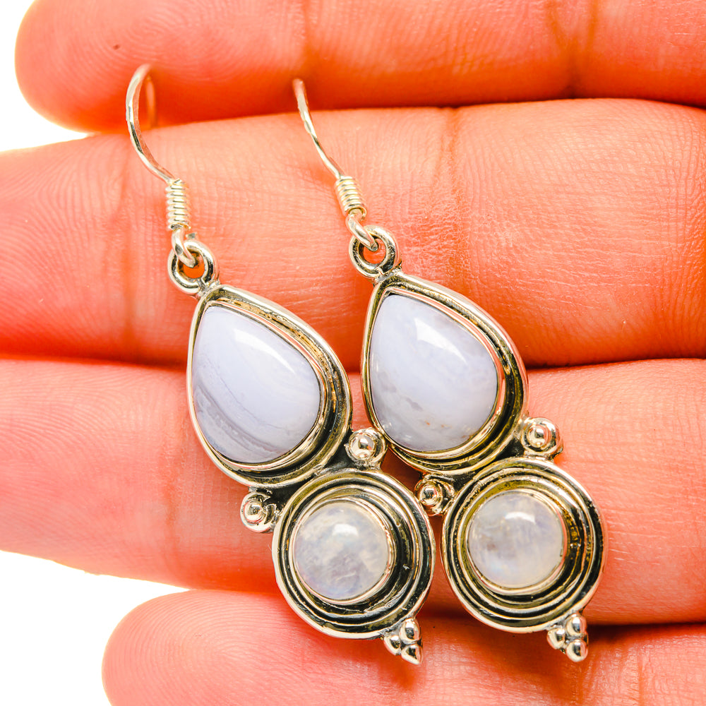 Gold-tone drop earrings with pale blue/white teardrop and round stones, hook backs