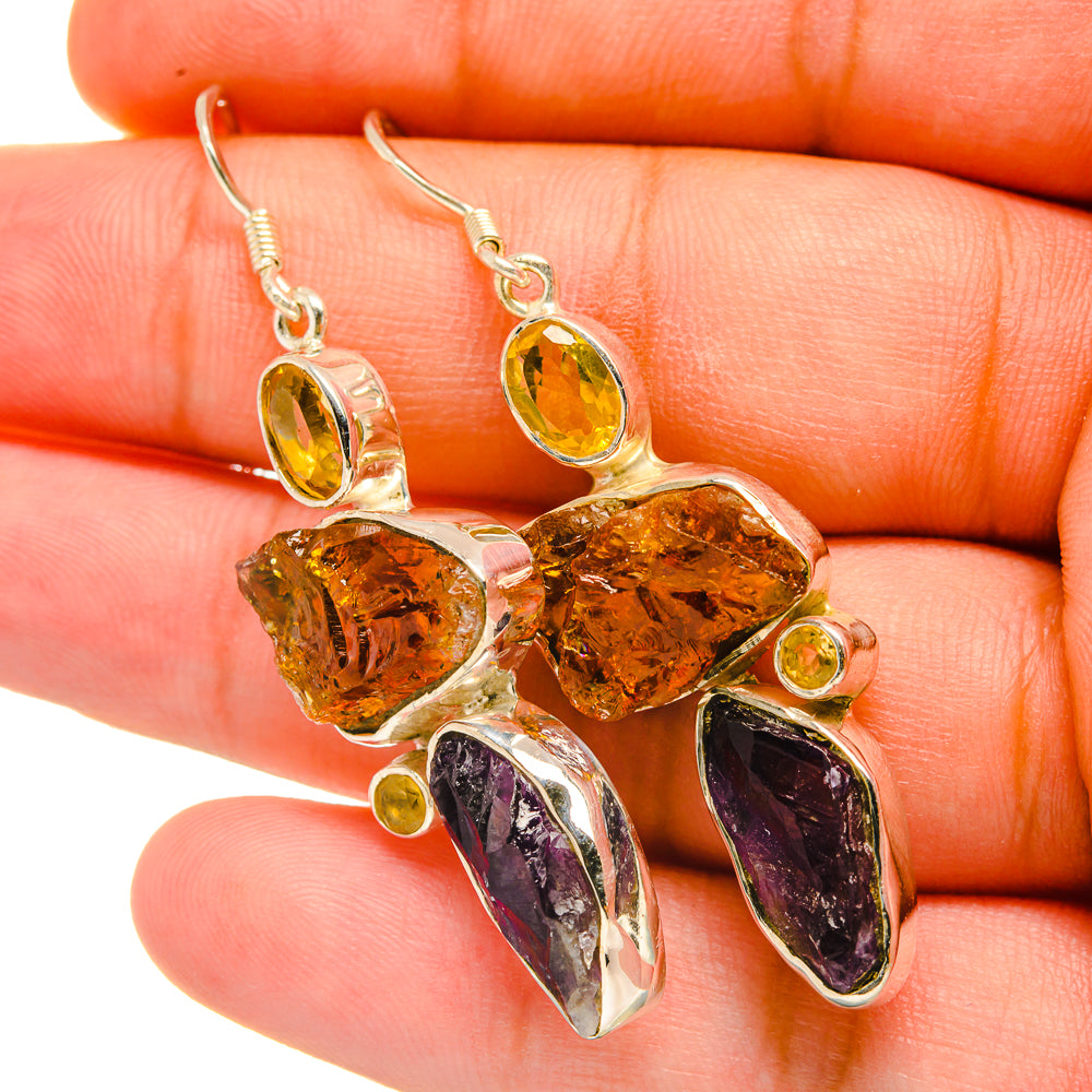 Rough amethyst and citrine earrings with silver prongs, purple teardrop and golden rough stones
