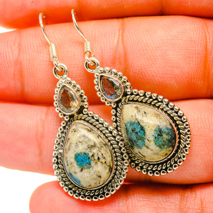 Oval-to-teardrop labradorite drop earrings with blue speckled stones in silver-tone settings