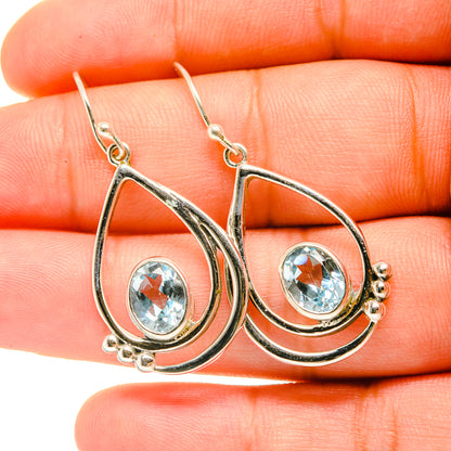 Sterling silver teardrop earrings with blue topaz gemstone drops and hook backs