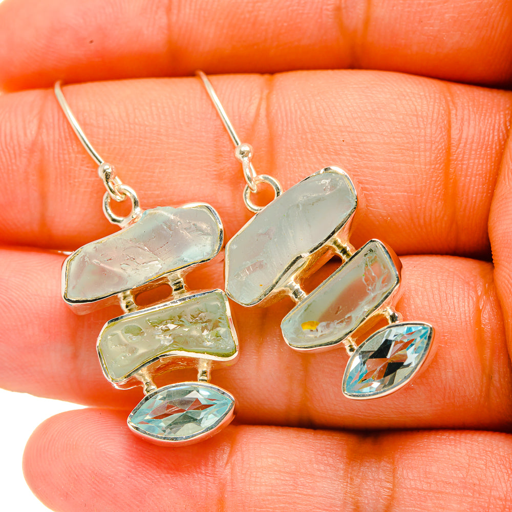 Rough aquamarine-style earrings with blue oval stones and silver-tone hook backs
