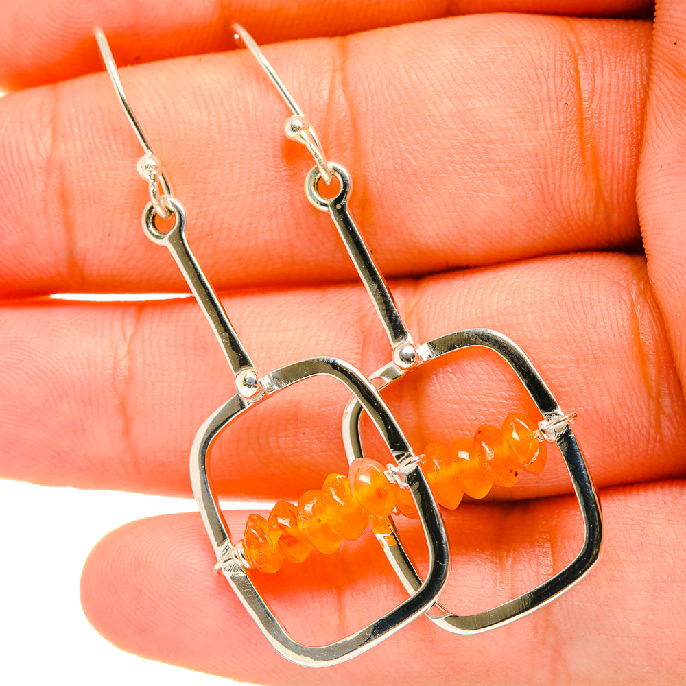 Silver heart drop earrings with orange carnelian beads on lever hooks