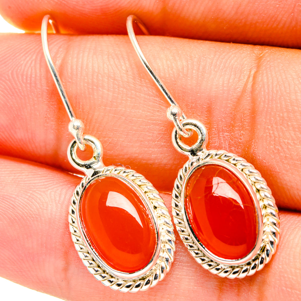 Red oval onyx dangle earrings, ornate silver-tone bezel and hook backs
