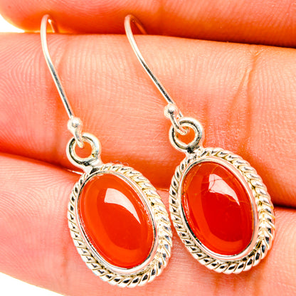 Red oval onyx dangle earrings, ornate silver-tone bezel and hook backs