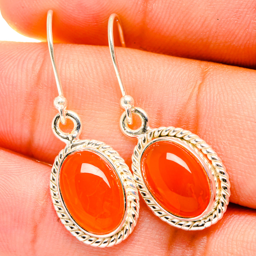 Orange oval carnelian earrings on silver hooks with decorative rope edging