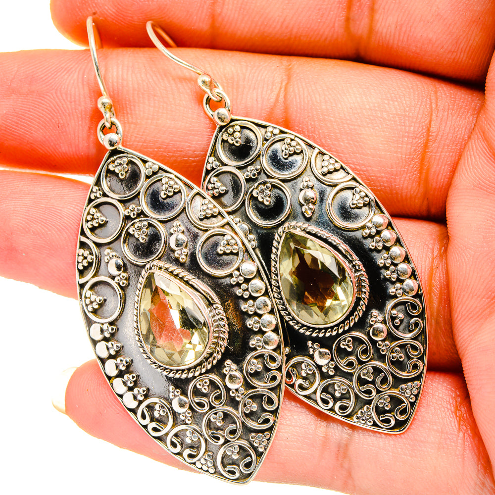 Sterling silver filigree teardrop earrings with faceted yellow-green center stones