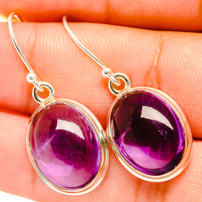 Sterling silver amethyst drop earrings with oval purple gemstones, hook backs