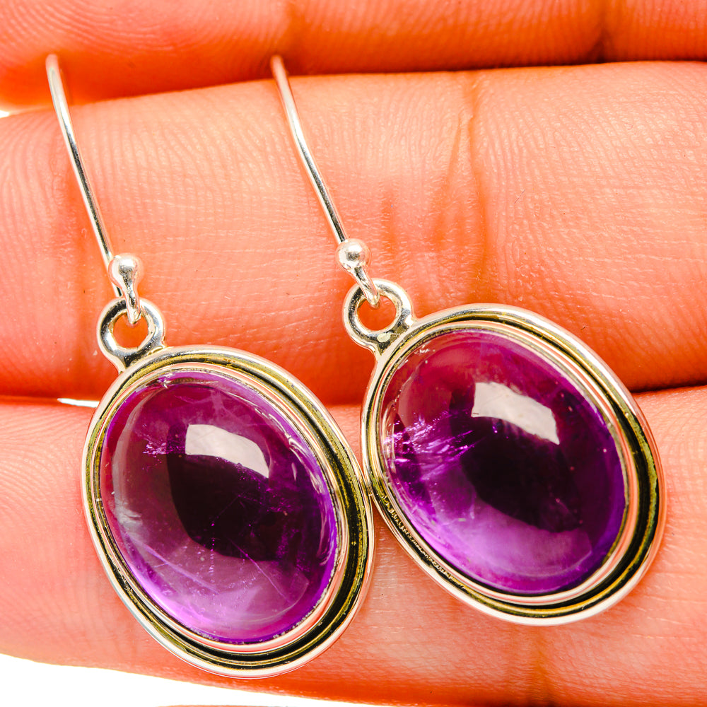 Oval purple amethyst drop earrings with silver bezels and fishhook backs