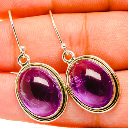 Oval purple amethyst drop earrings with silver bezels and fishhook backs