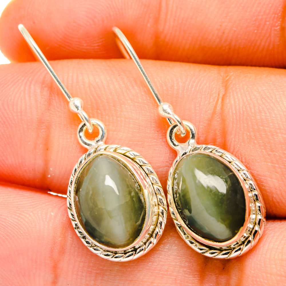 Sterling silver cat's eye drop earrings with oval green stone and ornate bezel