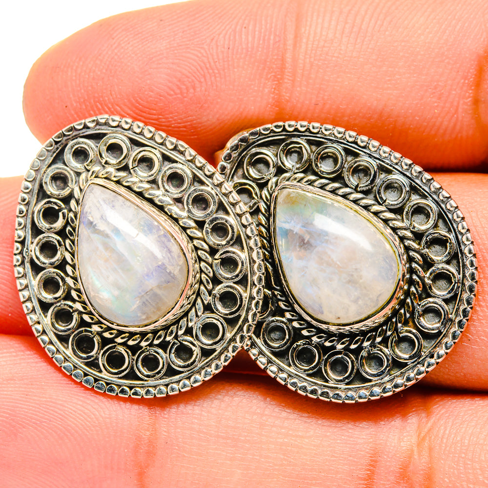 Moonstone teardrop earrings with iridescent white stones and engraved silver border