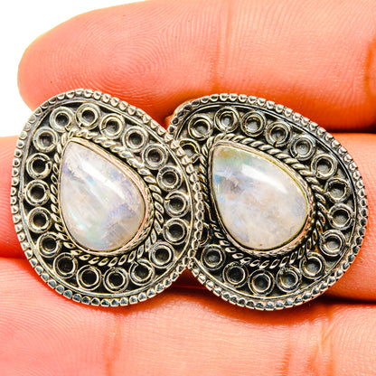 Moonstone teardrop earrings with iridescent white stones and engraved silver border