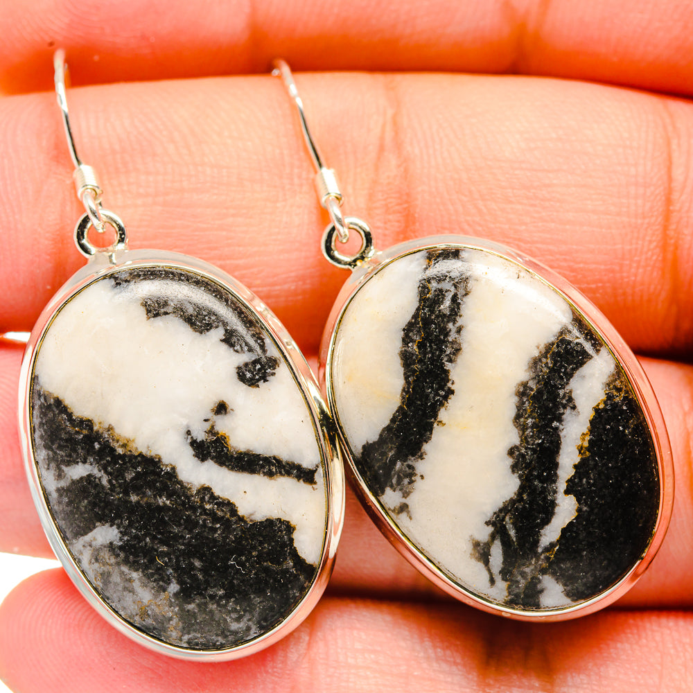 Oval pinolith jasper drop earrings with black-and-white stone and silver hooks