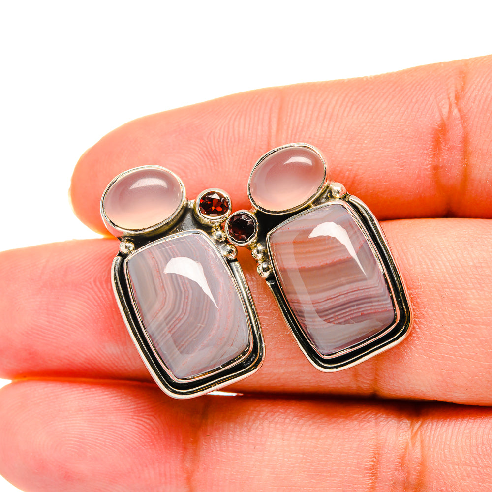 Sterling silver gemstone earrings close-up: pink rectangular stones with red round details