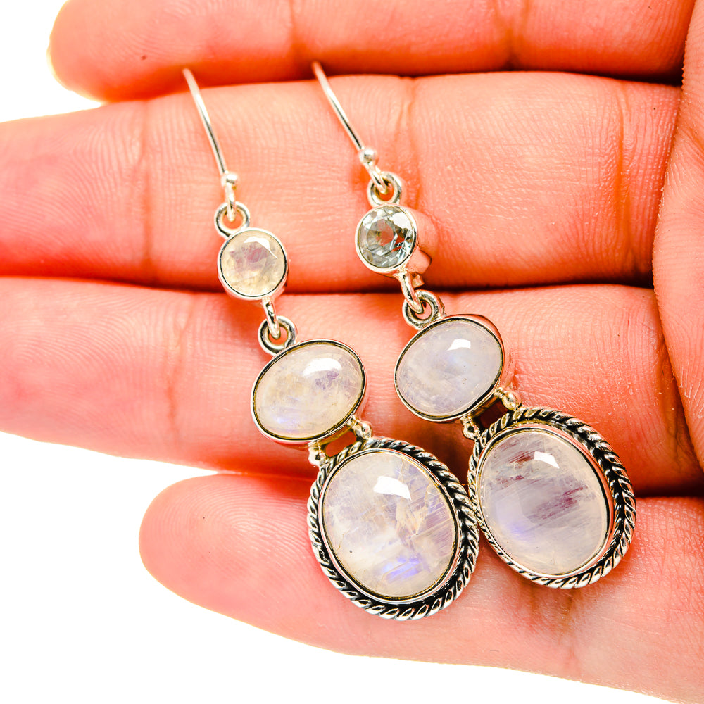 Sterling silver drop earrings with three round iridescent white cabochons and ornate frames