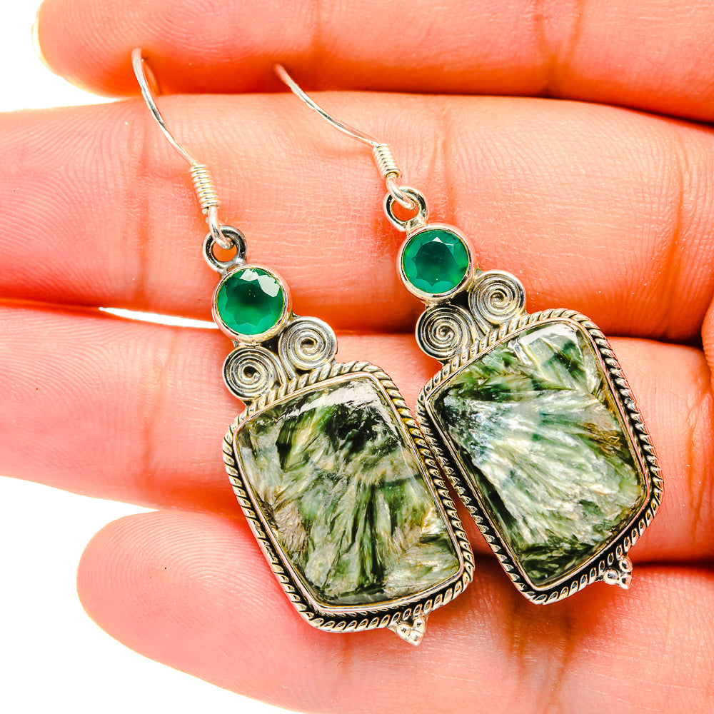 Green stone drop earrings with teal accents and silver filigree, hook backs
