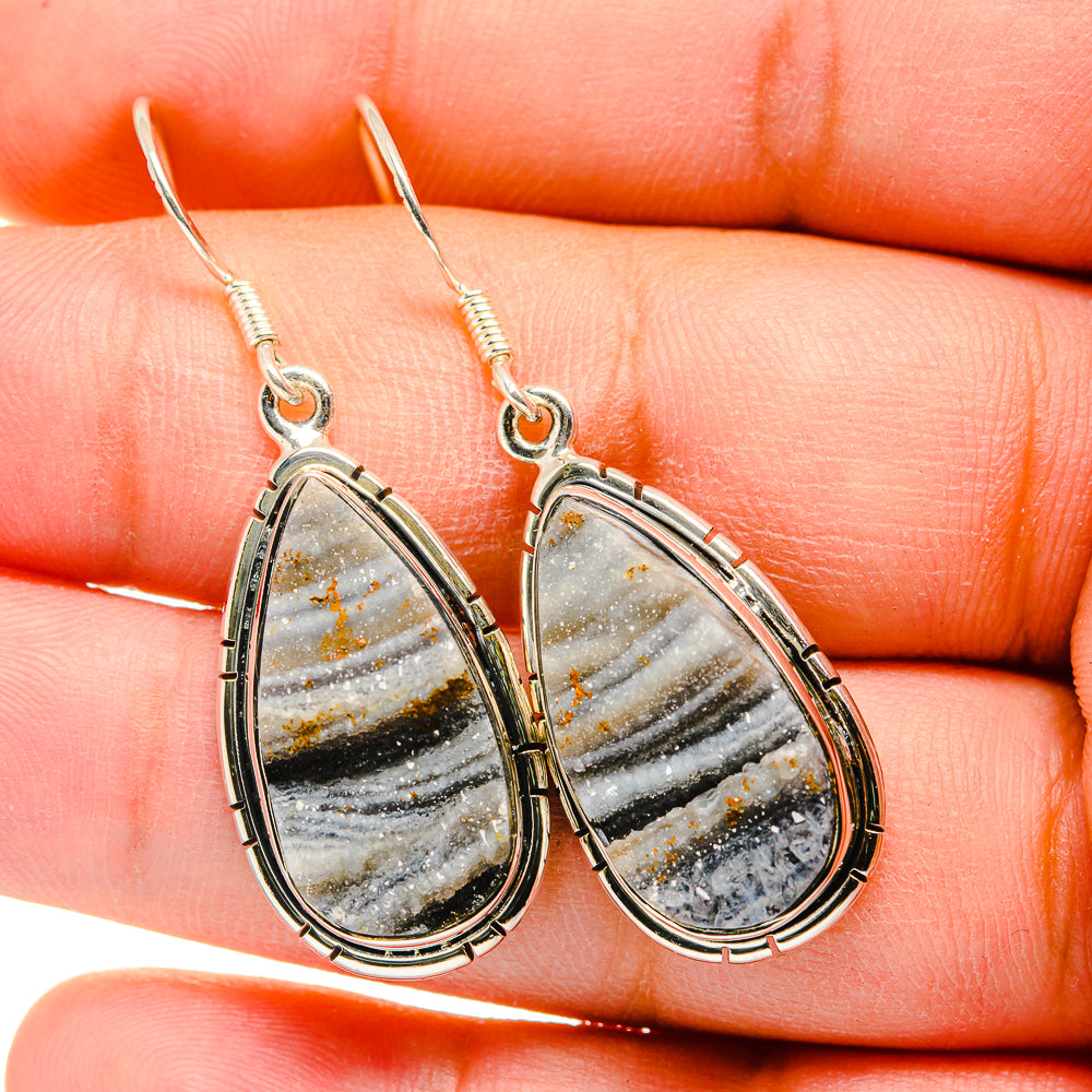 Teardrop druzy earrings with sterling silver frames, gold-toned hooks, gray stone