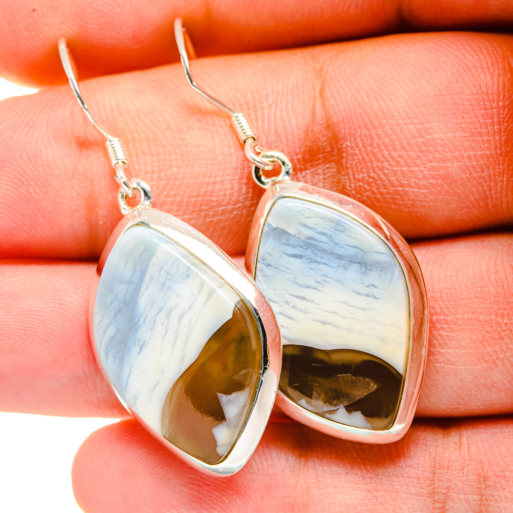 Sterling silver opal teardrop earrings with blue-white stone and gold back, drop style