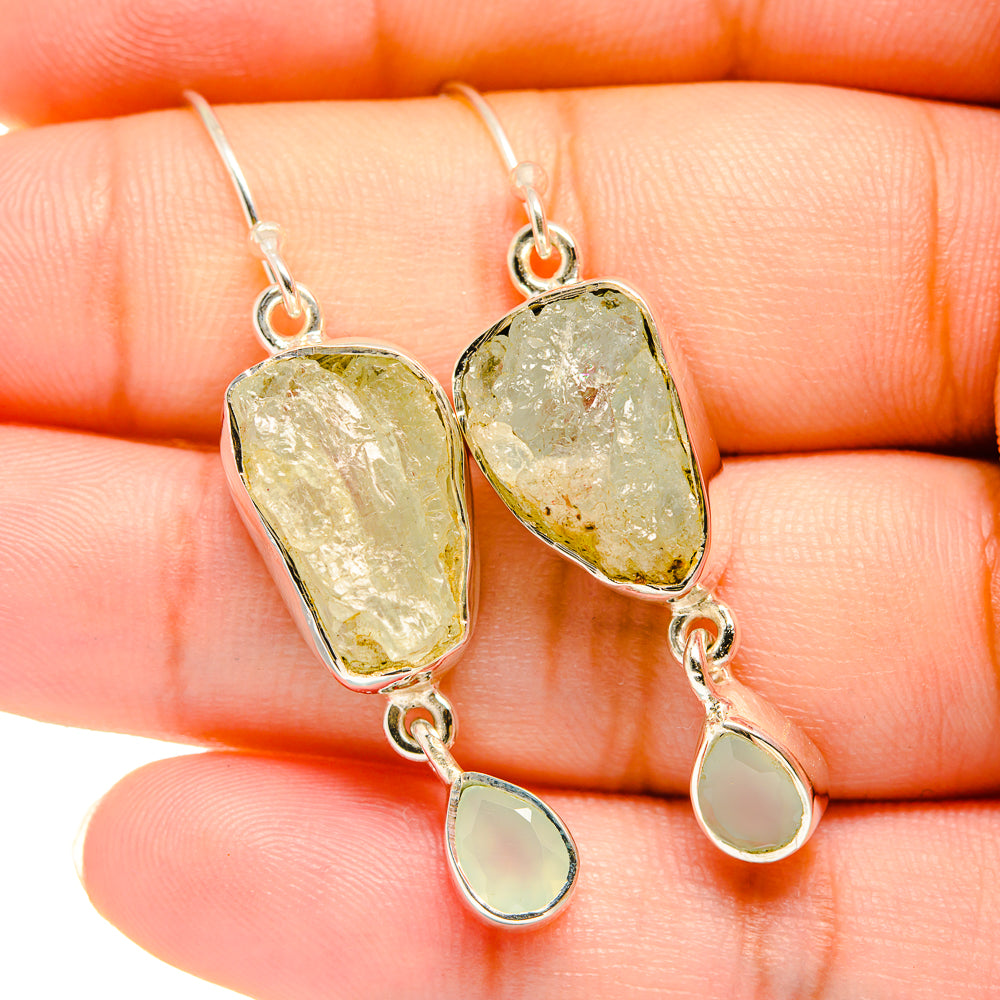 Aquamarine silver earrings close-up, rough stones with small teardrop charms