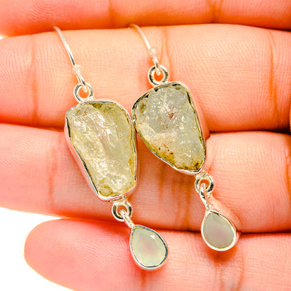 Aquamarine silver earrings close-up, rough stones with small teardrop charms
