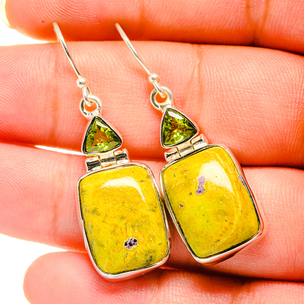 Peridot and square stone drop earrings, close-up on silver hooks