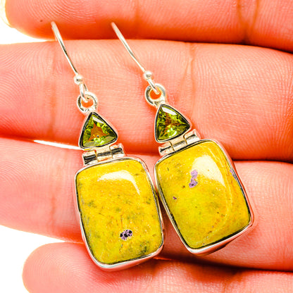 Peridot and square stone drop earrings, close-up on silver hooks