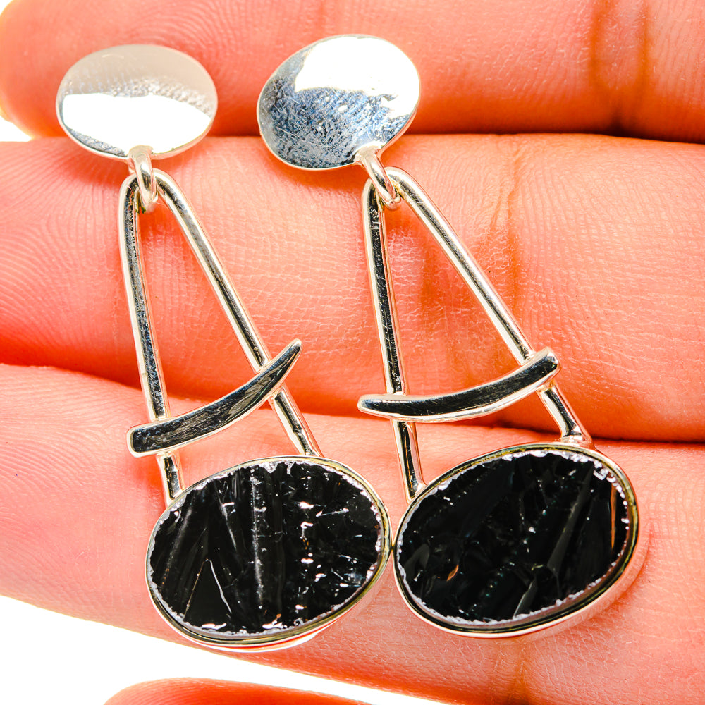 Silver-tone drop earrings with rough black round shungite stones and curved bars