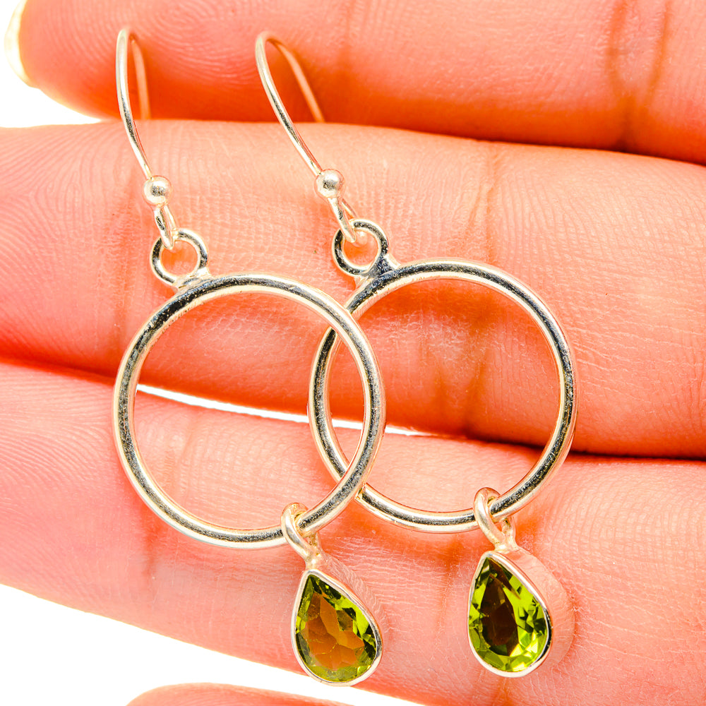 Sterling silver hoop earrings with green peridot teardrop charms