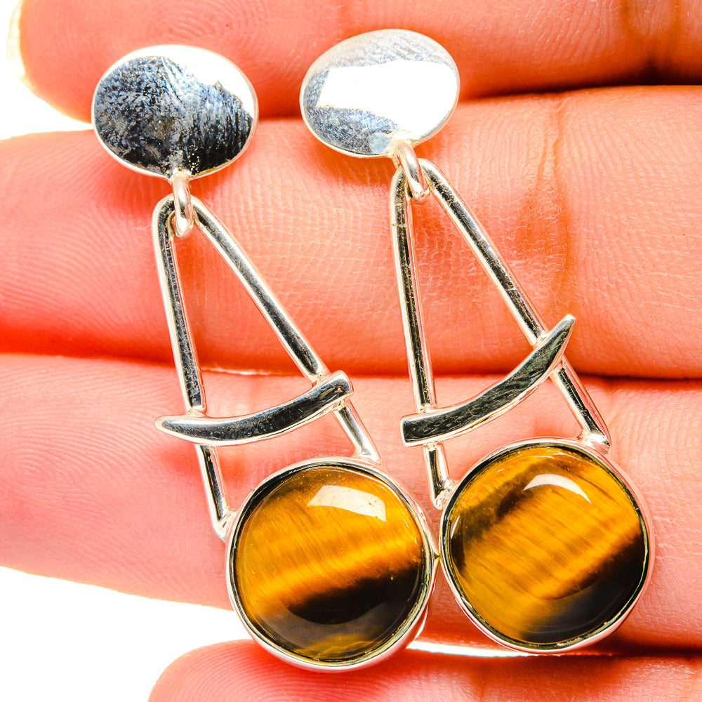 Tiger eye drop earrings closeup with round tiger eye stones and silver geometric links