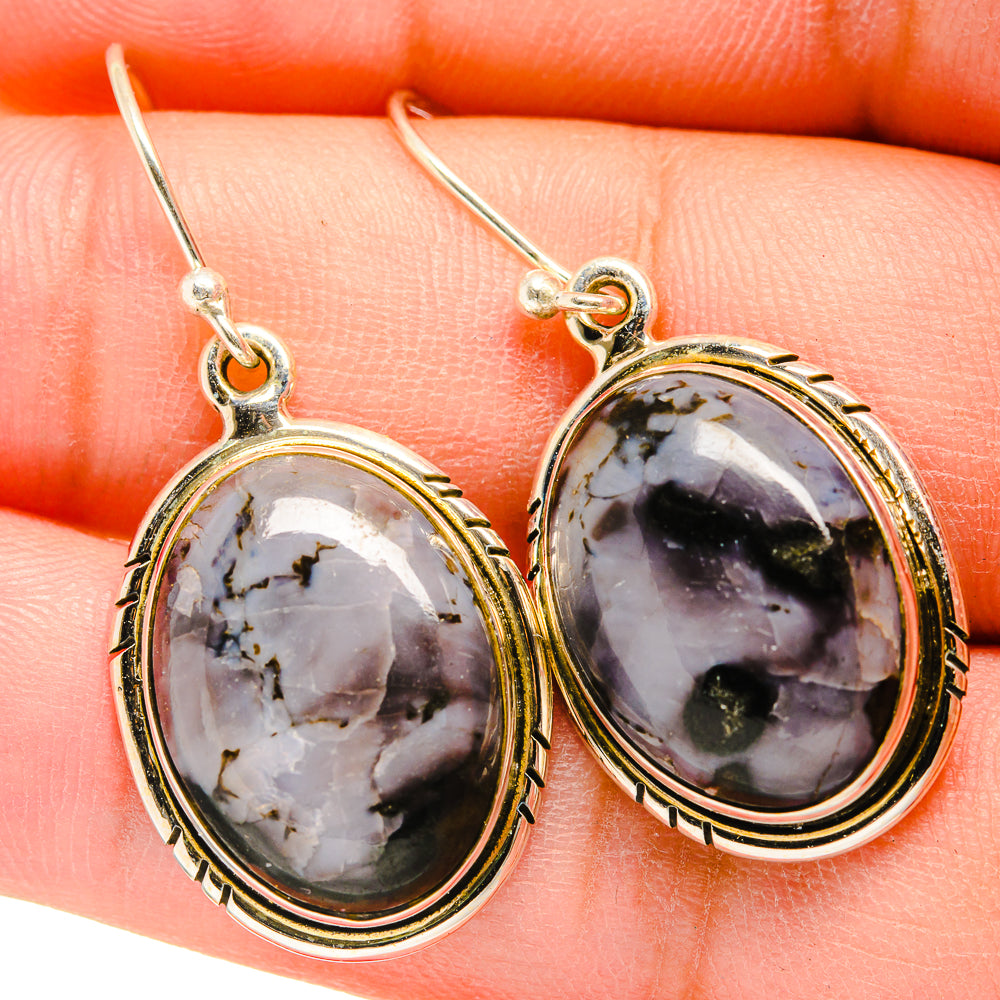 Gabbro stone oval drop earrings with detailed gold-tone rim and sterling silver hooks