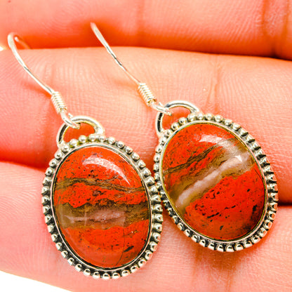 Red jasper oval drop earrings with textured silver border and dangling hooks