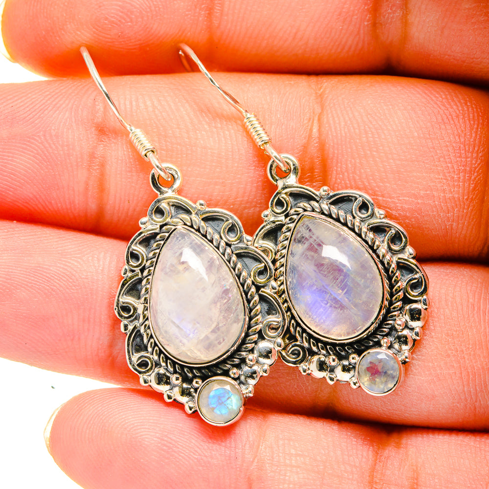 Silver moonstone drop earrings with oval iridescent stones and small blue cabochons