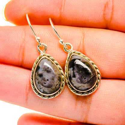 Oval gabbro stone drop earrings with silver hooks and gold-tone frame, black speckled stone