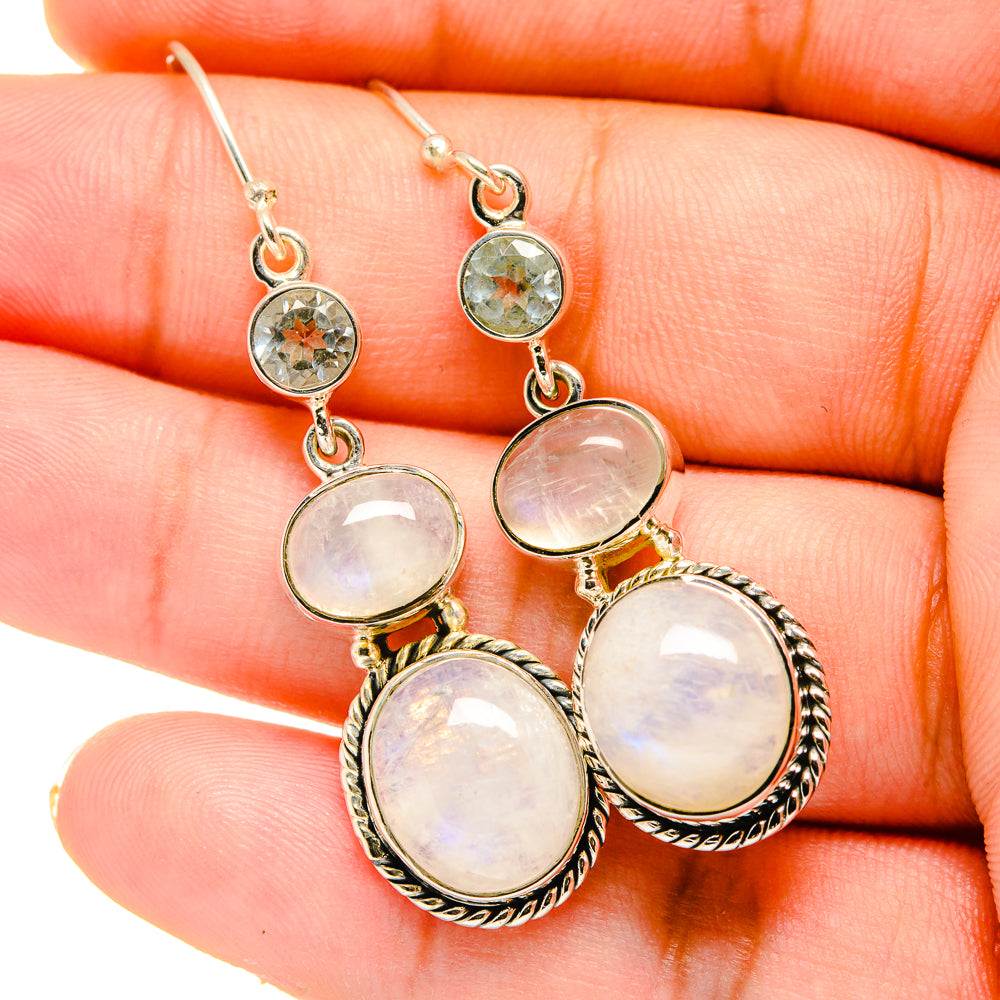 Opalescent moonstone dangle earrings with small blue round stones, silver setting