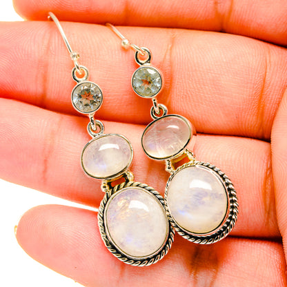 Opalescent moonstone dangle earrings with small blue round stones, silver setting