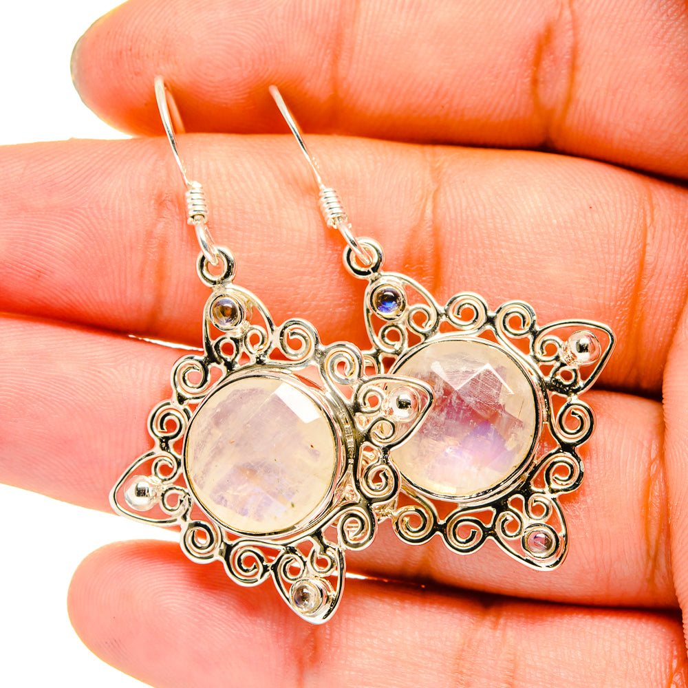 Silver-tone filigree moonstone drop earrings with rainbow iridescent centers