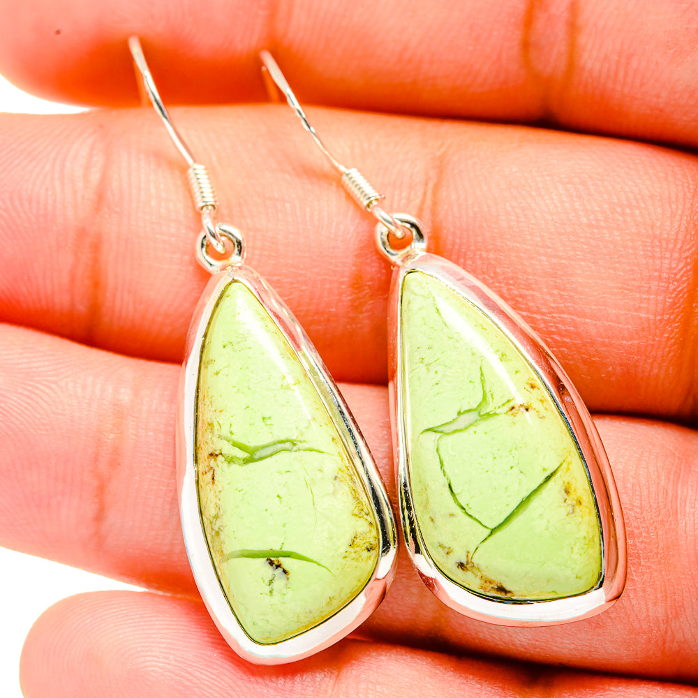 Teardrop chrysoprase earrings close-up: lime-green stones with silver drop frames.