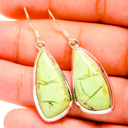 Teardrop chrysoprase earrings close-up: lime-green stones with silver drop frames.