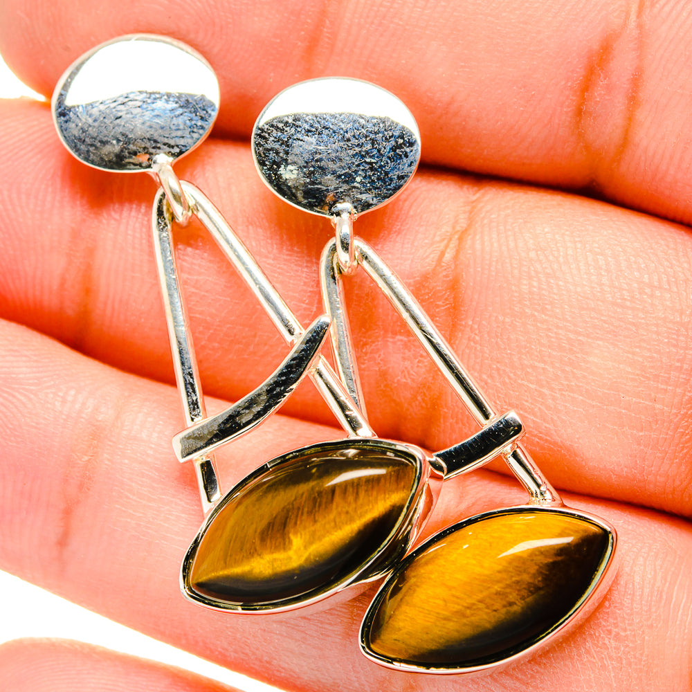 Tiger eye drop earrings with oval amber stones, silver-tone curved bars, hook backs
