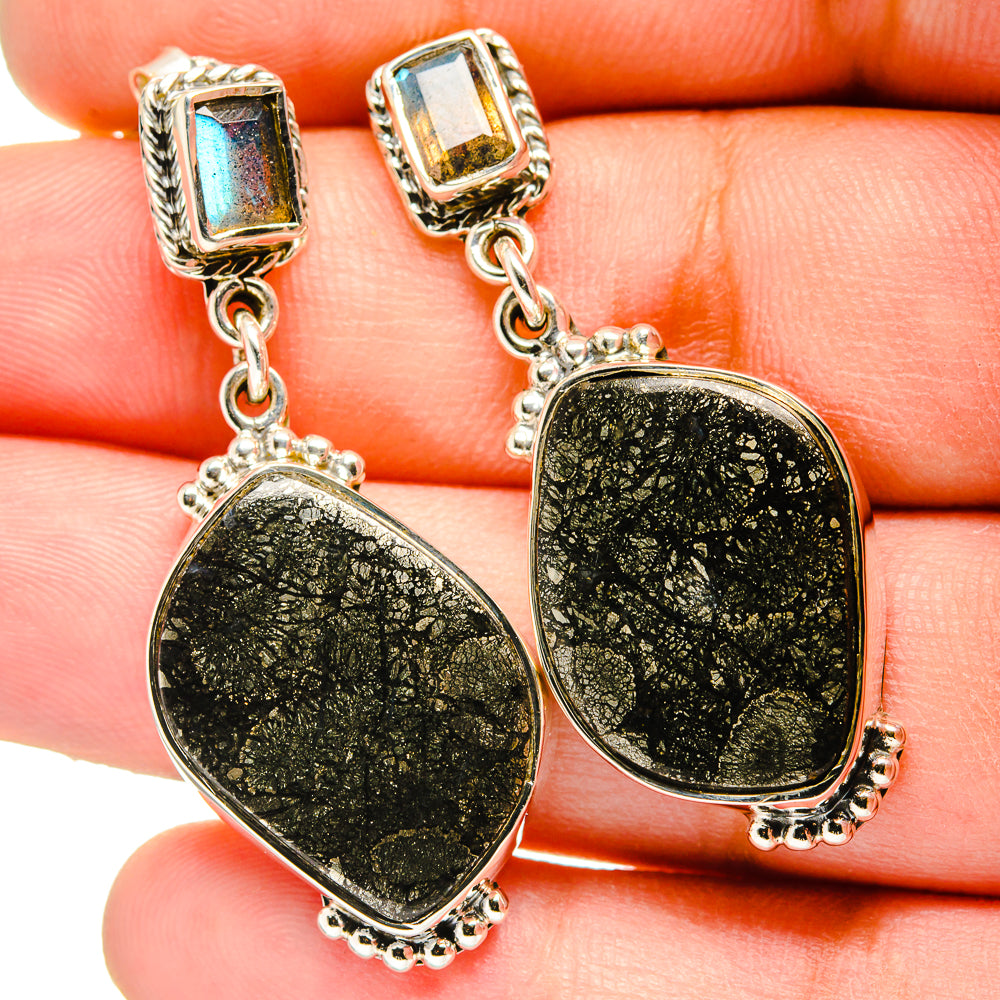 Sterling silver drop earrings with square blue accents and textured black-green oval dangles