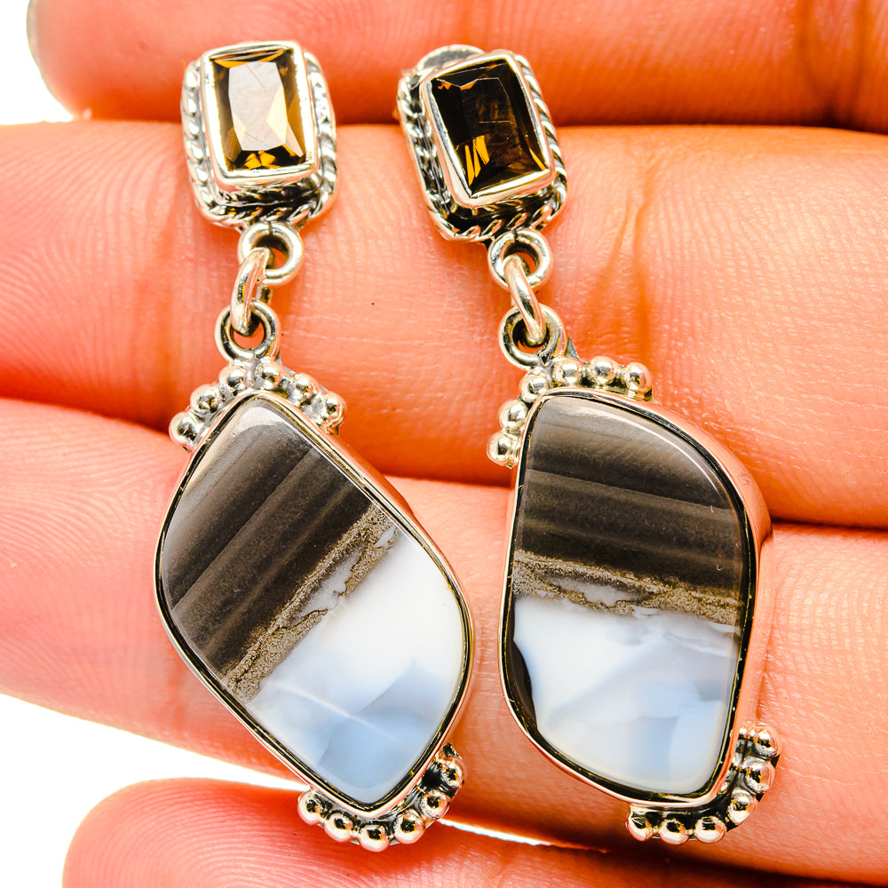 Sterling silver teardrop earrings with iridescent moonstone-like stones and dangling chains